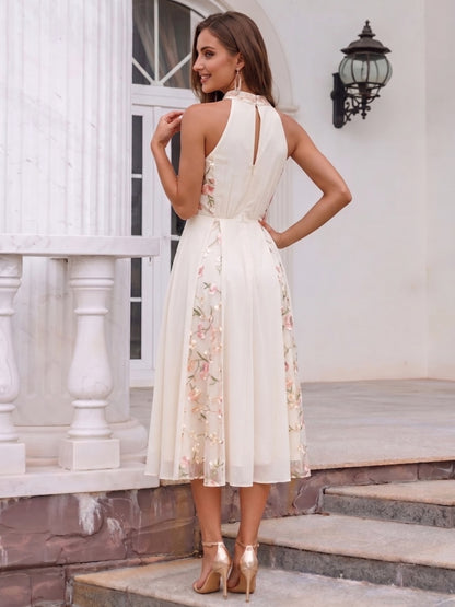 Robe de cocktail midi trapèze, col licou sans manches, broderie et fronces