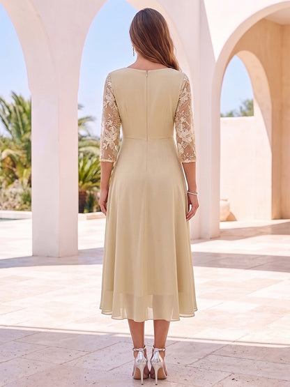 Robe de cocktail midi trapèze, col rond, manches 3/4, broderie et volants