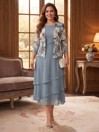Robe trapèze/princesse en mousseline grande taille pour mère de la mariée : encolure ronde, manches 3/4, longueur mi-mollet, avec veste et volants