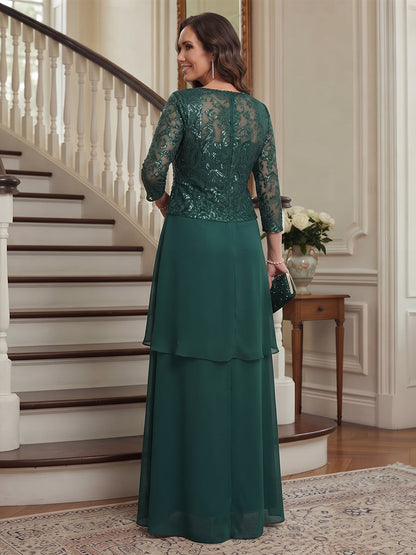 Robe de mère de la mariée longue en mousseline, coupe trapèze/princesse, encolure arrondie, manches 3/4, avec motifs appliqués et veste