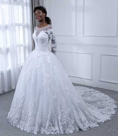 Robe de mariée en tulle à manches longues et col transparent avec appliques de perles