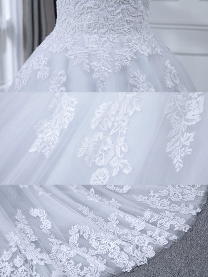 Robe de mariée en tulle à manches longues et col transparent avec appliques de perles